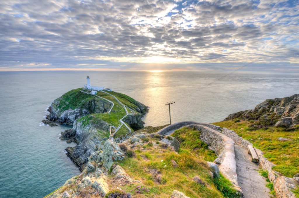 View of the Cemaes Bay lighthouse as the sun sets in Anglesey.