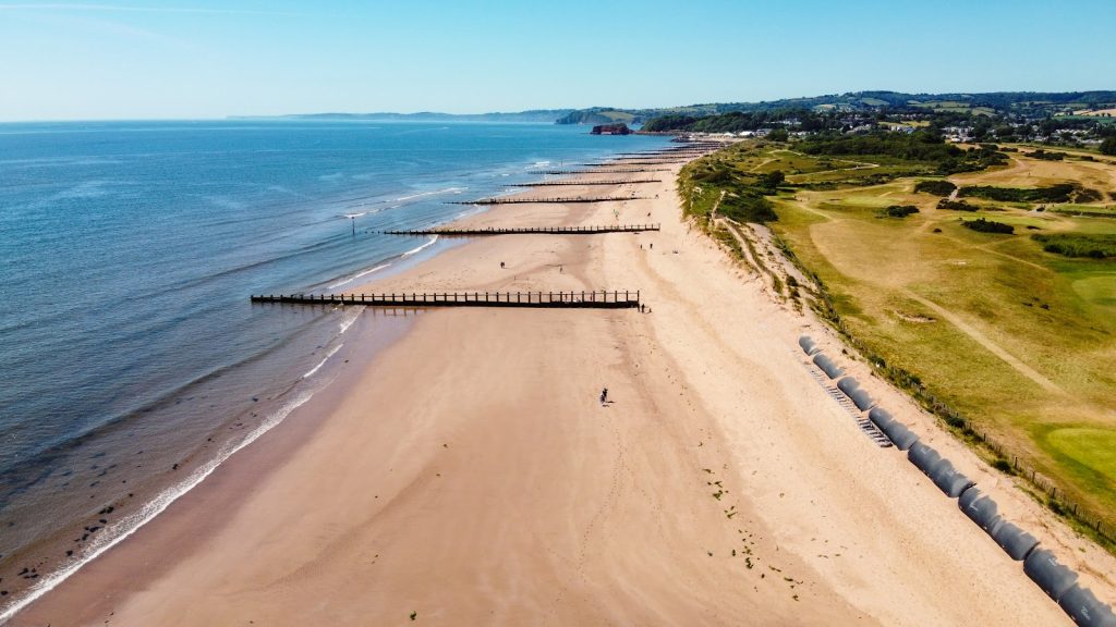 Sand and wooden groynes on Dawlish Warren Beach, Devon.