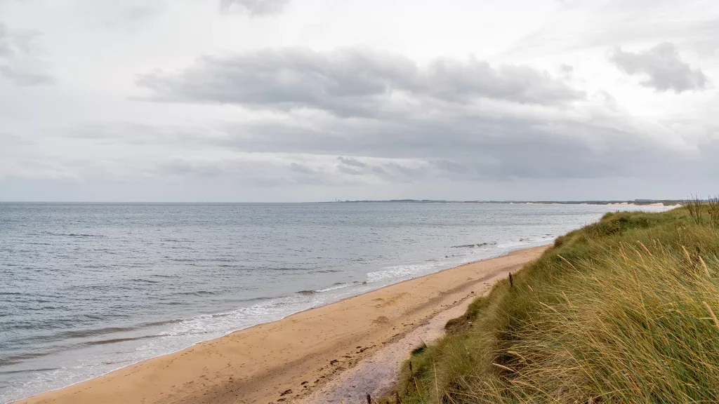 Sandy beach at Druridge Bay on a cloudy winter's day.