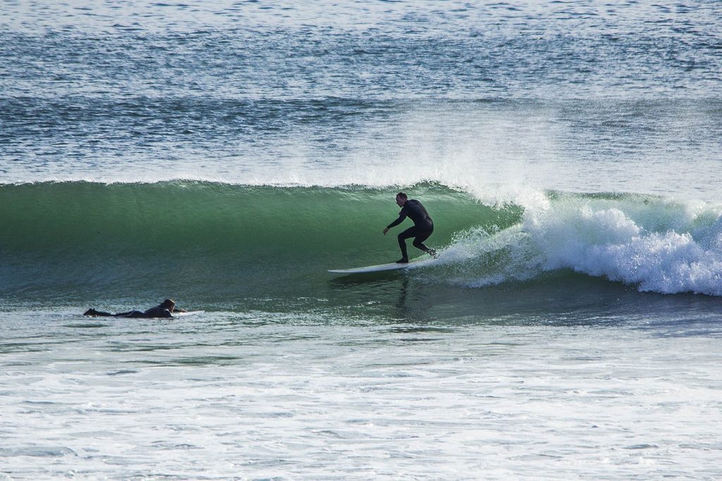 Wave riding at Lahinch Beach in Ireland, UK.