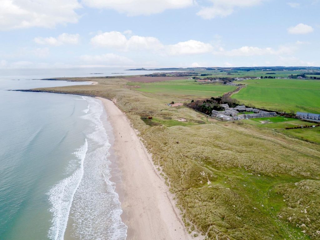 Aerial view of Link House Beach in Beadnell Bay, Northumberland, UK.