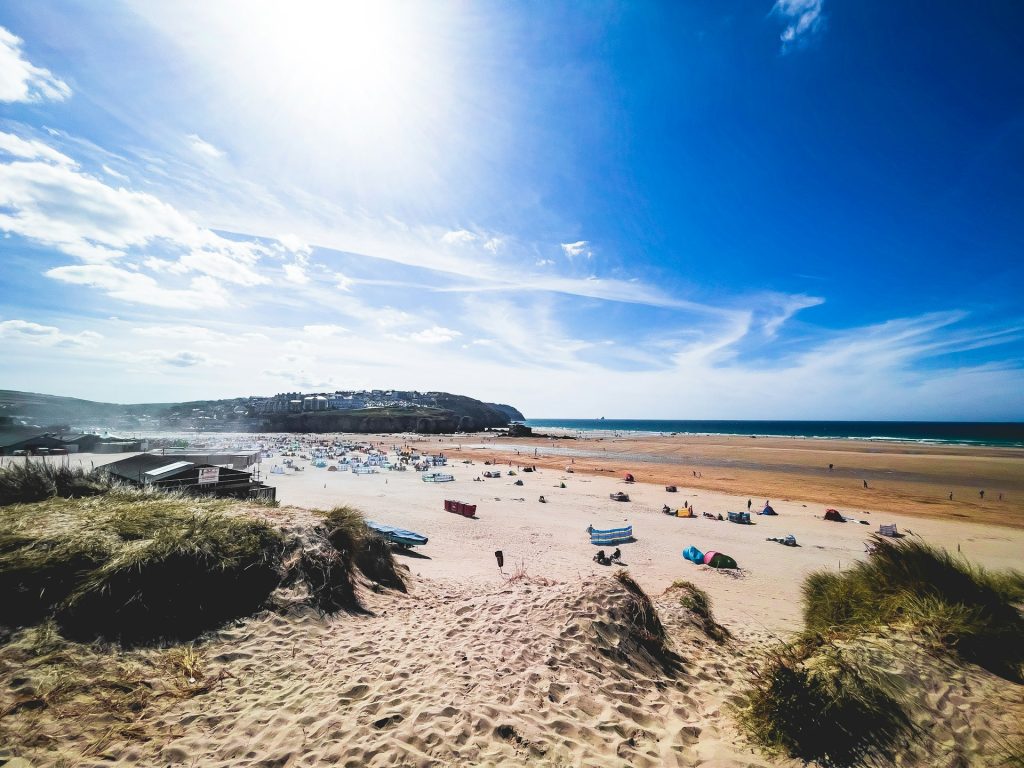 Lots of people on Perranporth Beach, Cornwall on a summer's day.