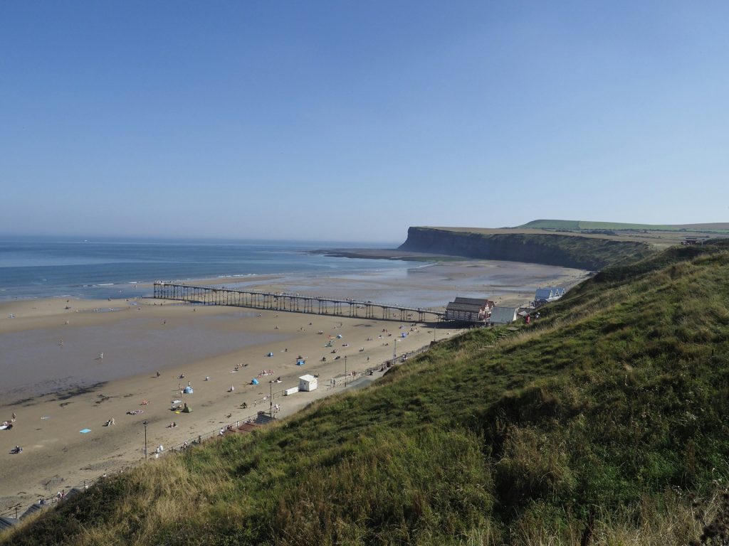 Saltburn-by-the-Sea beach and pier on a sunny day in summer.