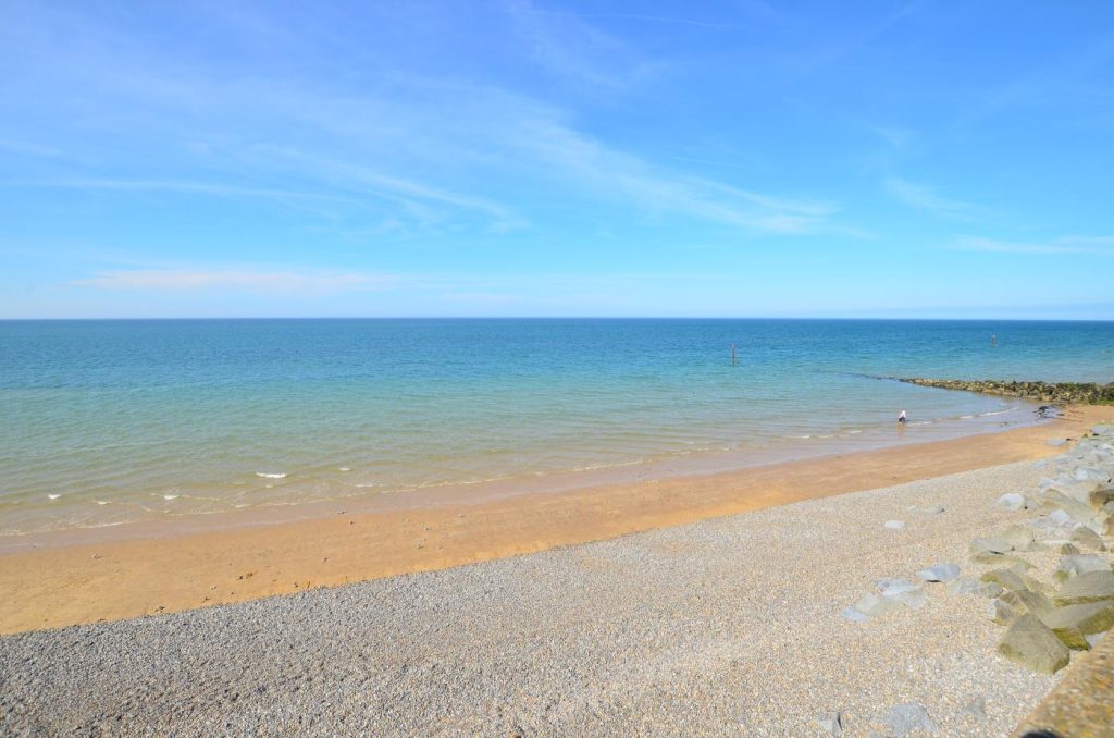 Picturesque blue sea and the shingle beach at Sheringham, Norfolk.