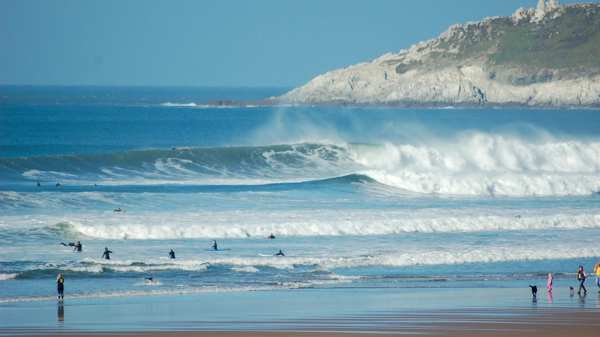 Surfers in the water at Croyde Beach in Devon during a big swell.