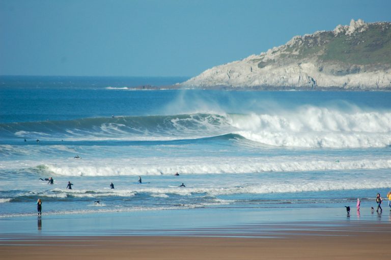 Surfers in the water at Croyde Beach in Devon during a big swell.