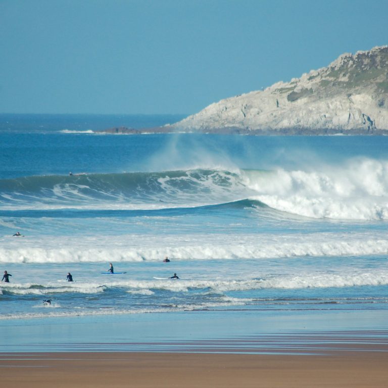Surfers in the water at Croyde Beach in Devon during a big swell.