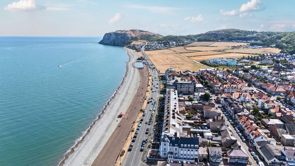 Aerial view of Llandudno Beach and seafront buildings.