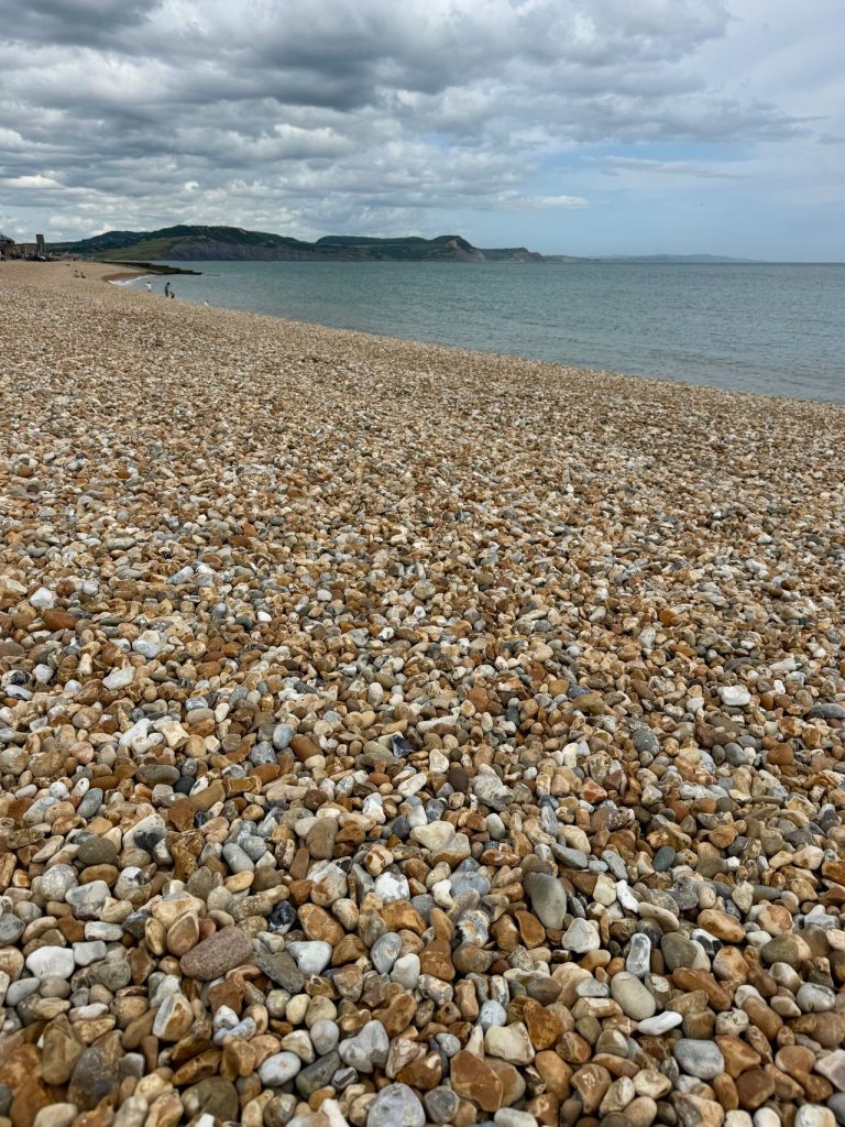Pebble beach in Lyme Regis on a cloudy day in autumn.