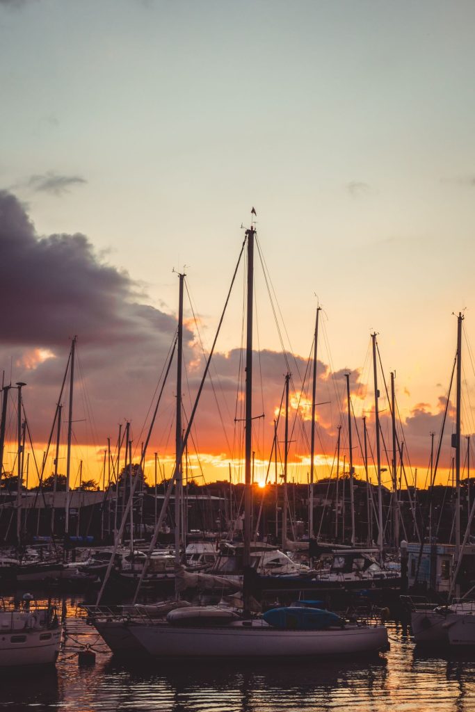 Lots of sailboats docked at Lymington Marina during sunset.