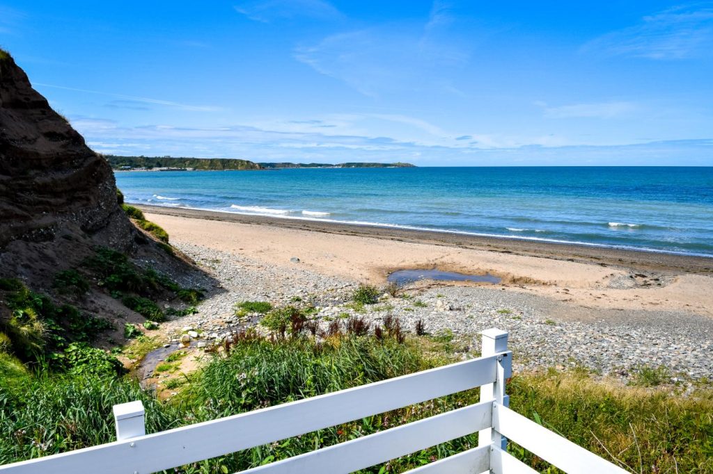 Overlooking Nefyn beach on a sunny day with clear skies.