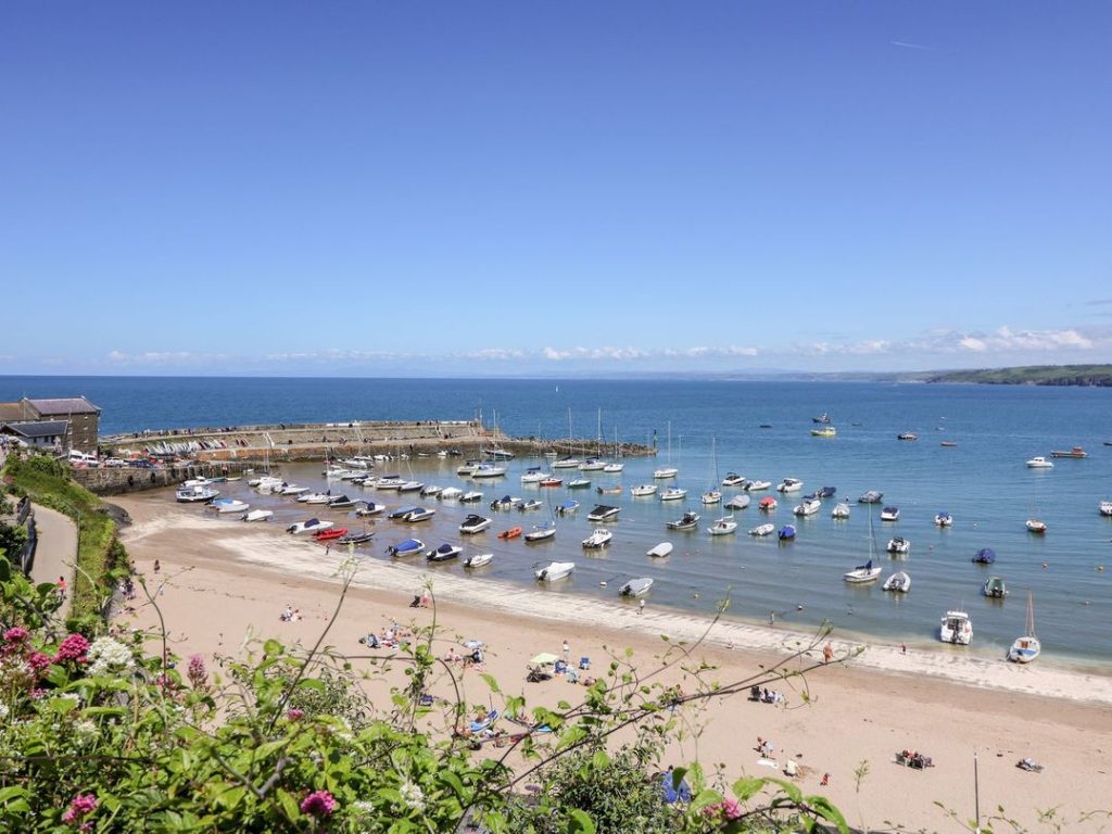 Lots of colourful boats moored in New Quay harbour, Ceredigion.