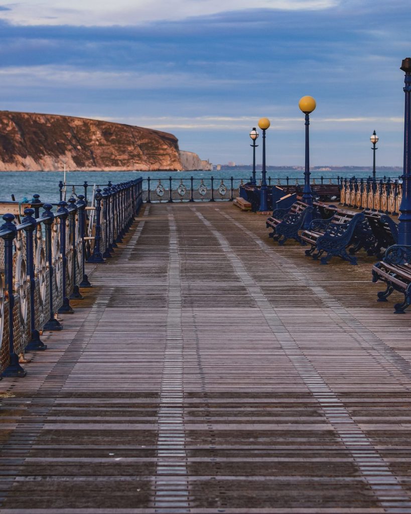 View along Swanage Pier with the ocean in the background.