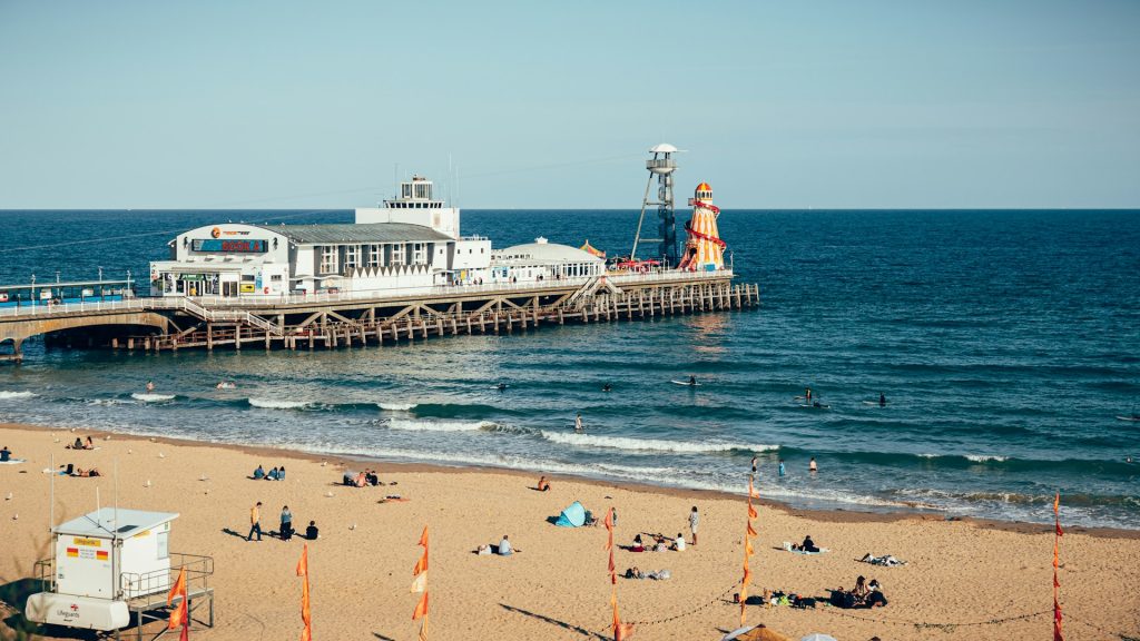 View of Bournemouth Pier on a sunny day with calm seas and a blue sky.