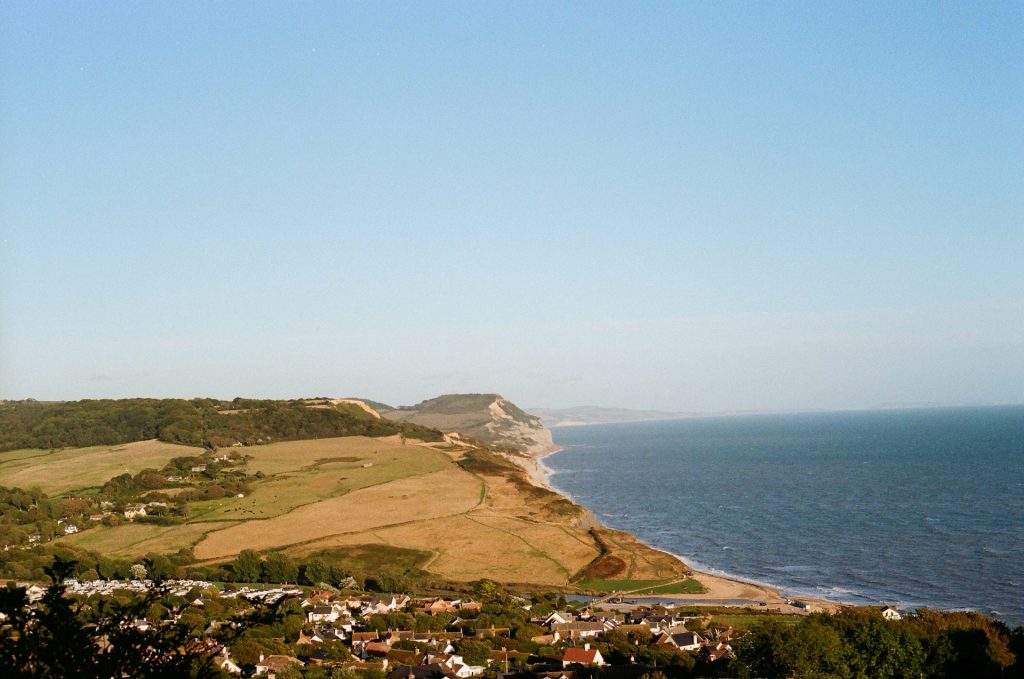 View along the coast including Charmouth and Bridport on a calm, sunny day.