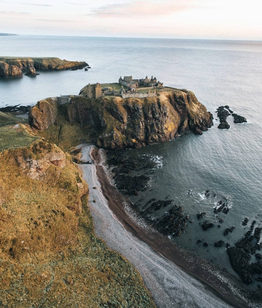 Dunnottar Castle on a rocky headland surrounded by steep cliffs, Stonehaven, UK.