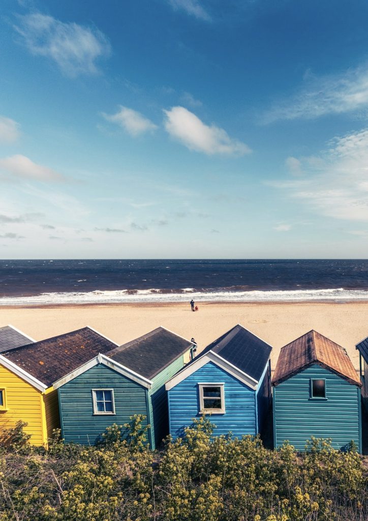 Overlooking Southwold Beach in Suffolk with colourful beach huts in the foreground.