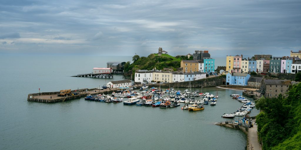 Tenby harbour under a wintery grey and cloudy sky.