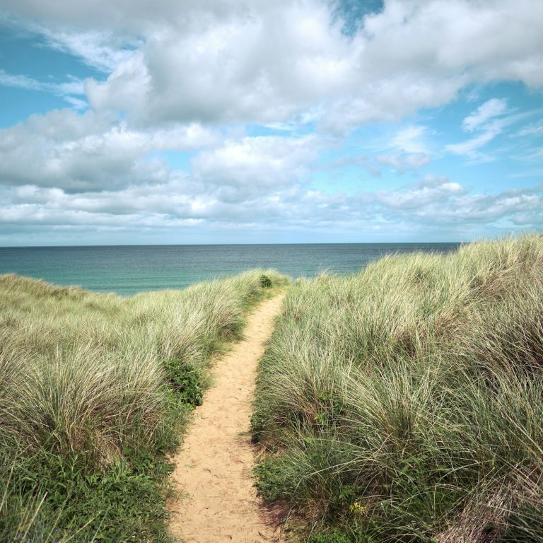 Coastal path through the grassy hills in Melvich, Scottish Highlands, UK.