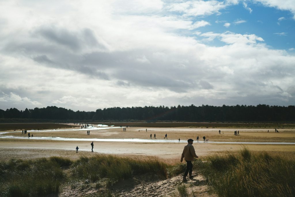 People walking on Holkham Beach at Wells-next-the-Sea in Winter.