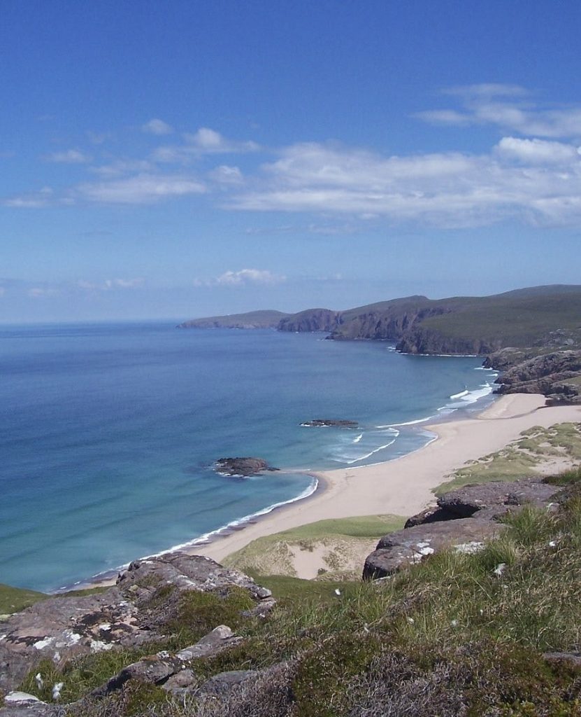 Sandwood Bay backed by large sand dunes and cliffs, Scottish Highlands, UK.
